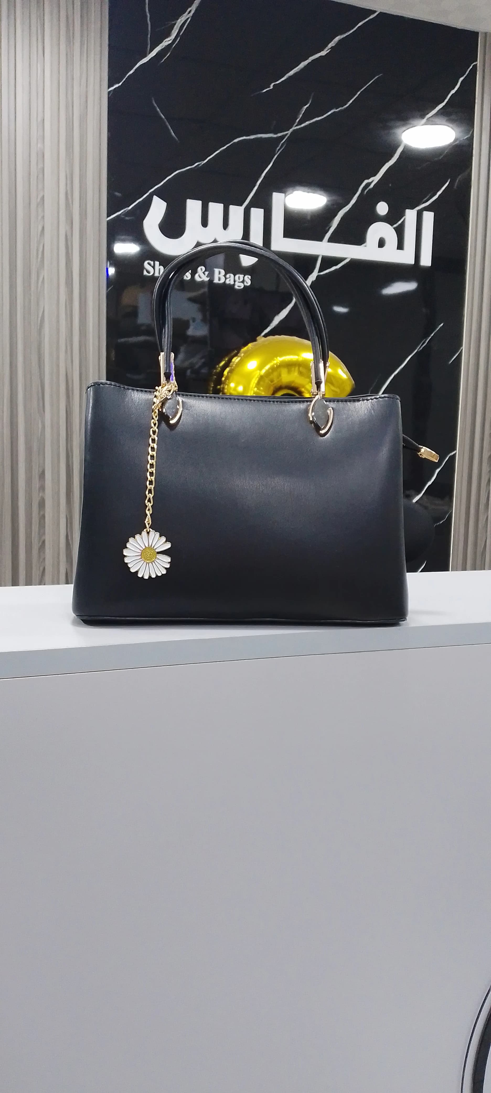 Genuine leather handbag with a pendant for women