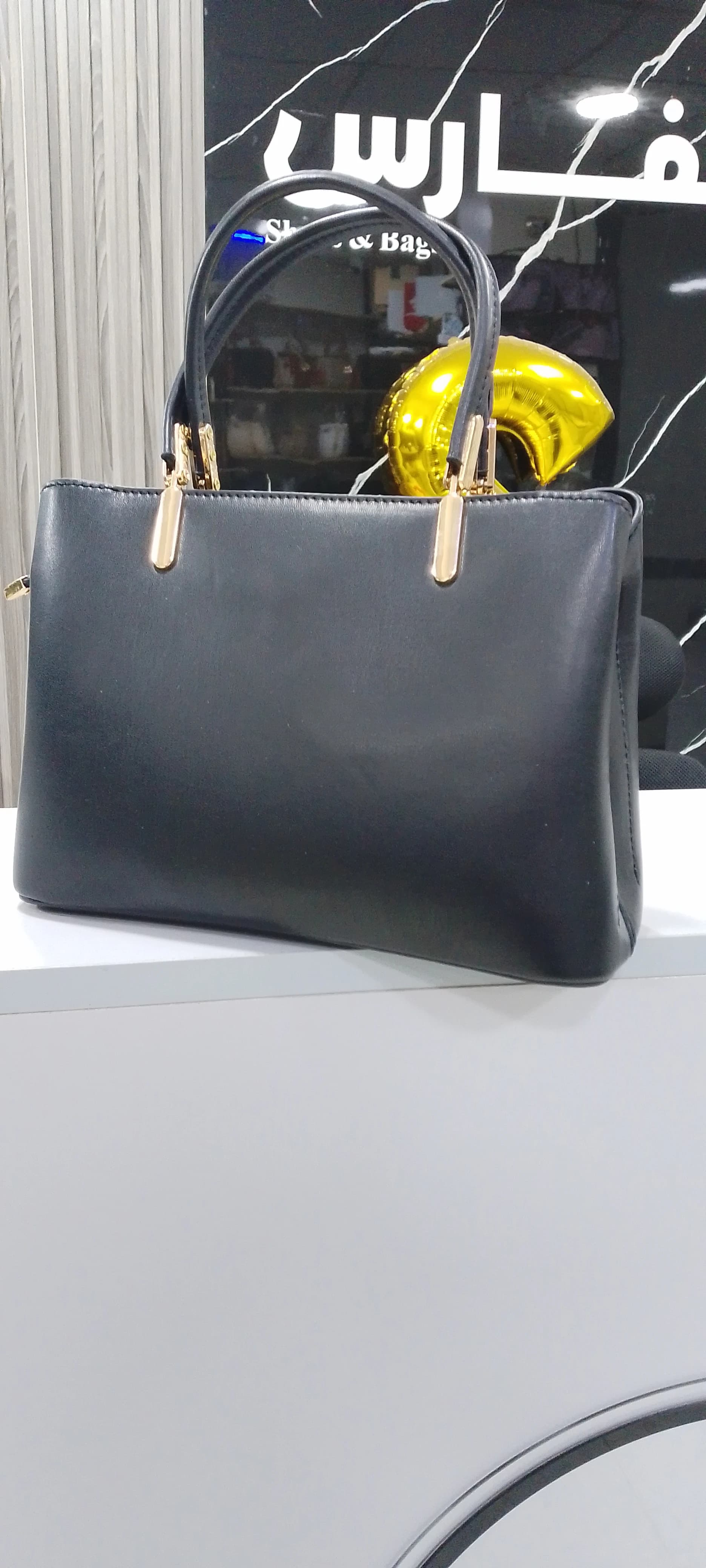 Genuine leather handbag with a pendant for women