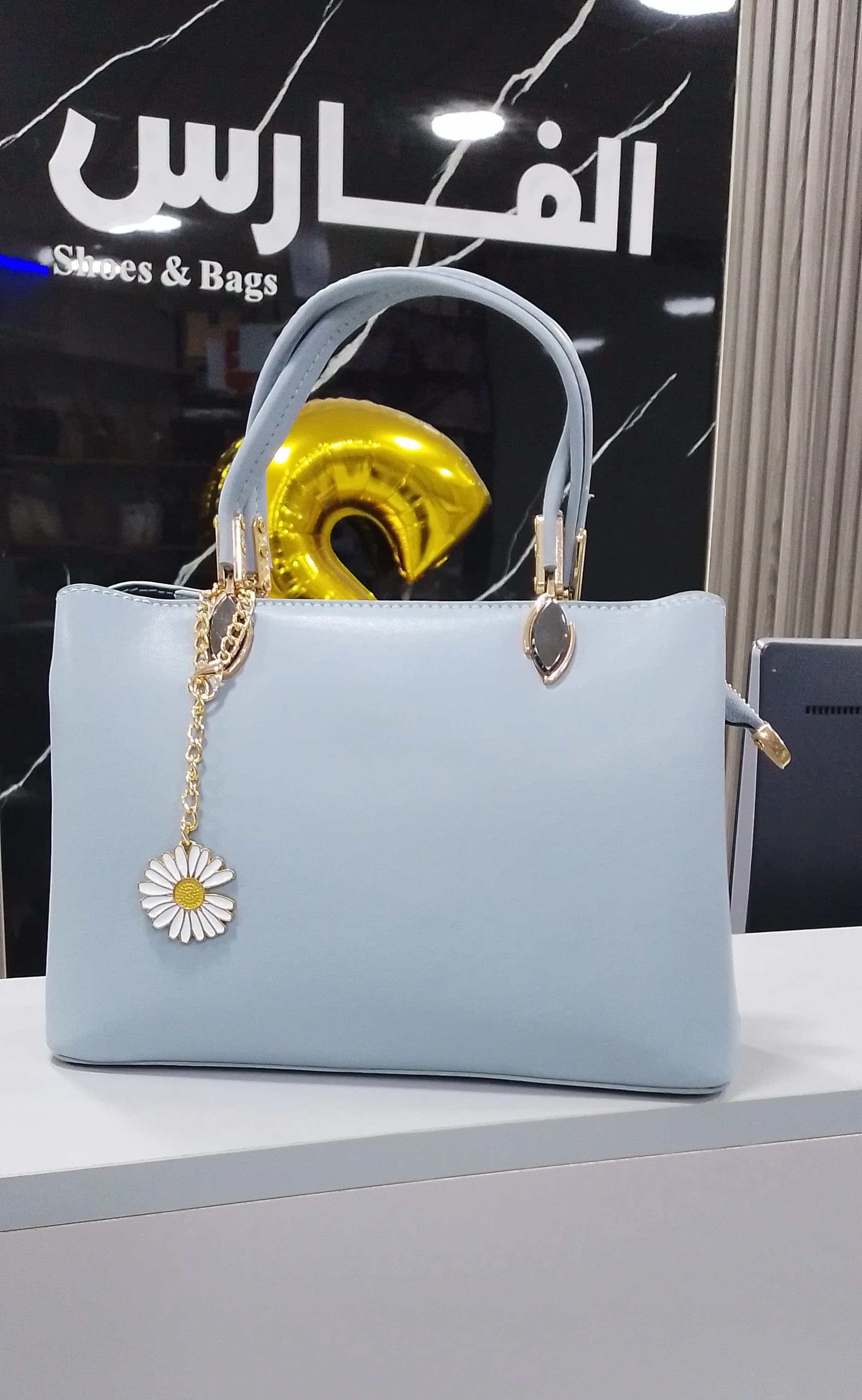 Genuine leather handbag with a pendant for women