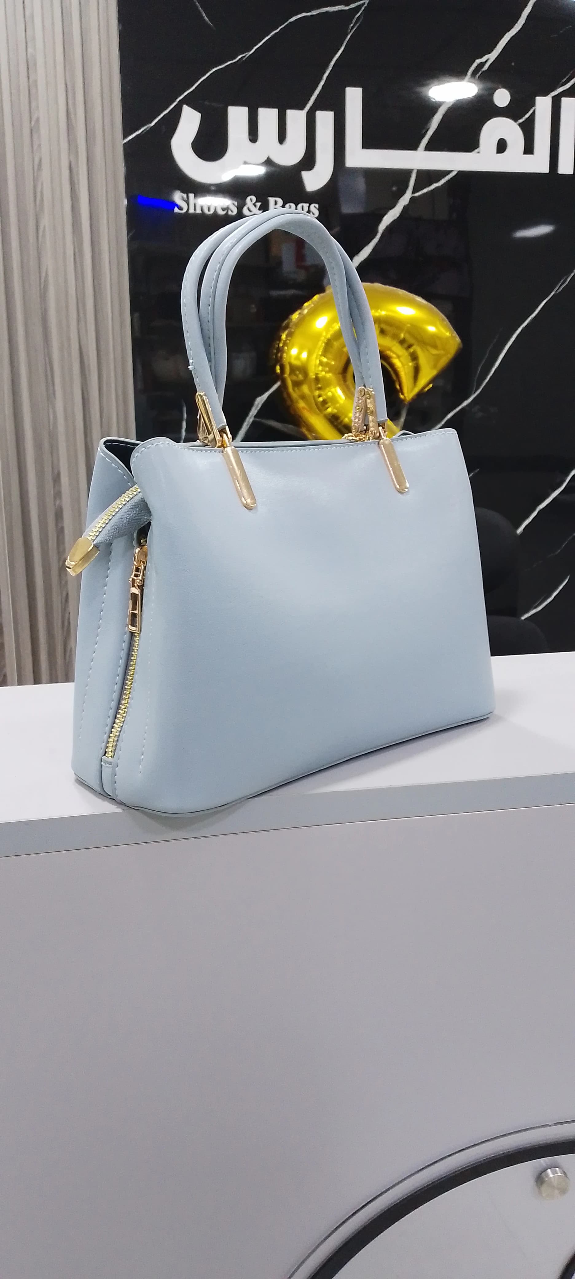 Genuine leather handbag with a pendant for women